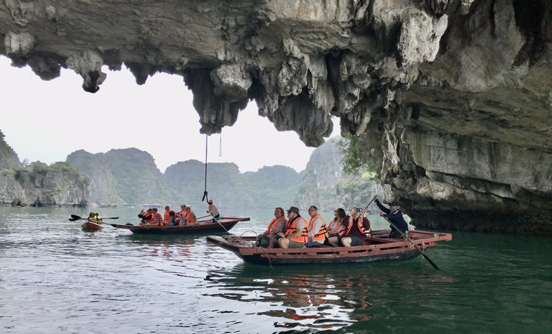 Ha Long Bay, with two boats are wadering around two small islands